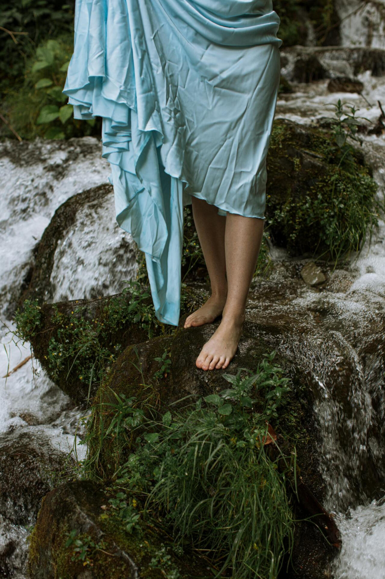 earthing woman's barefeet on moss